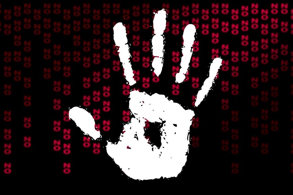 Picture of a white handprint with red words No behind it on black background.